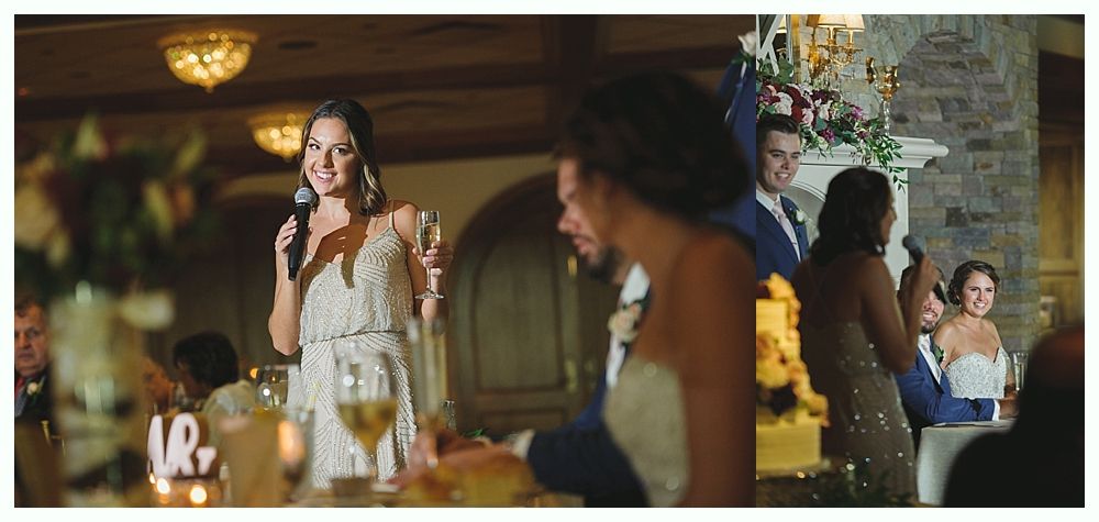 Woman giving a speech at a wedding, smiling with a microphone in hand, and a happy couple is looking.