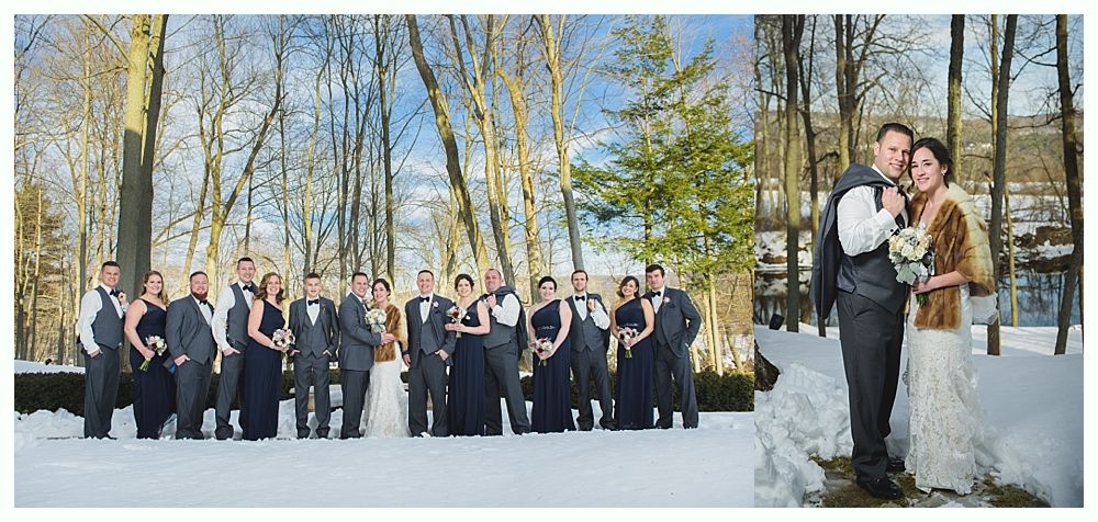 Wedding party poses in snowy setting, bride and groom on the right. Dark attire. Trees.