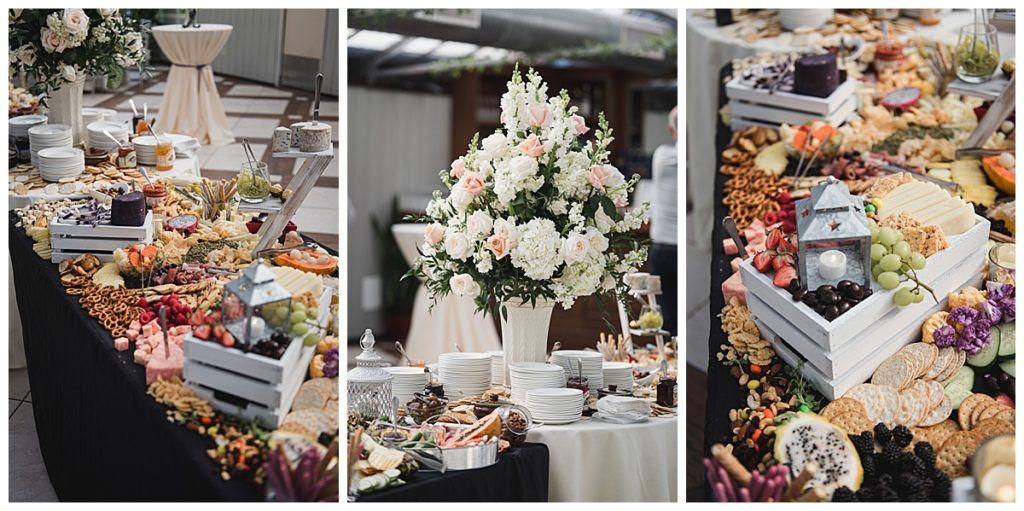 Buffet with floral arrangements and food displays.