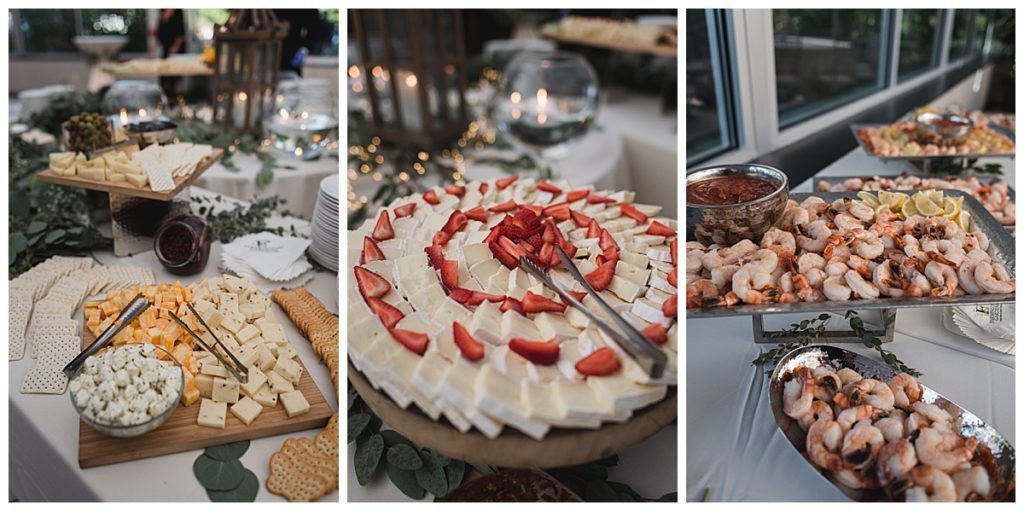 Buffet table with cheese, strawberries, and shrimp.