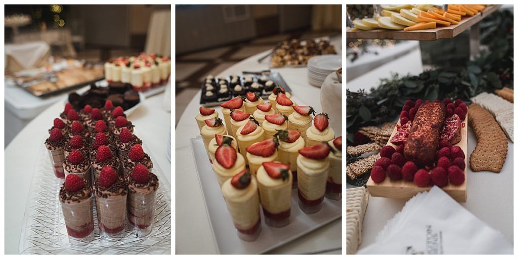 Dessert table with various pastries and cheese. Treats include cupcakes, cheese and crackers, and chocolate desserts.