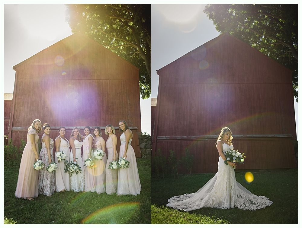 Wedding party in front of a red barn. Bride with bridesmaids, soft light, floral bouquets.