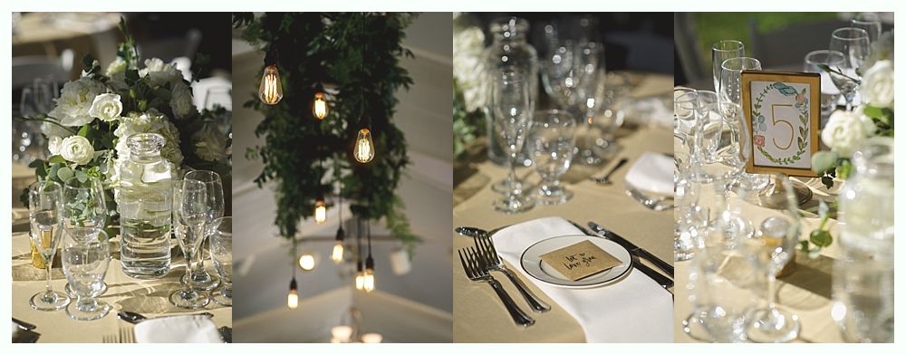 Elegant table setting with floral arrangements, hanging lights, and place settings.