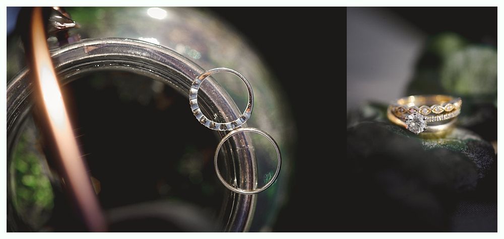 Wedding rings on a dark background, one pair hanging, the other stacked.
