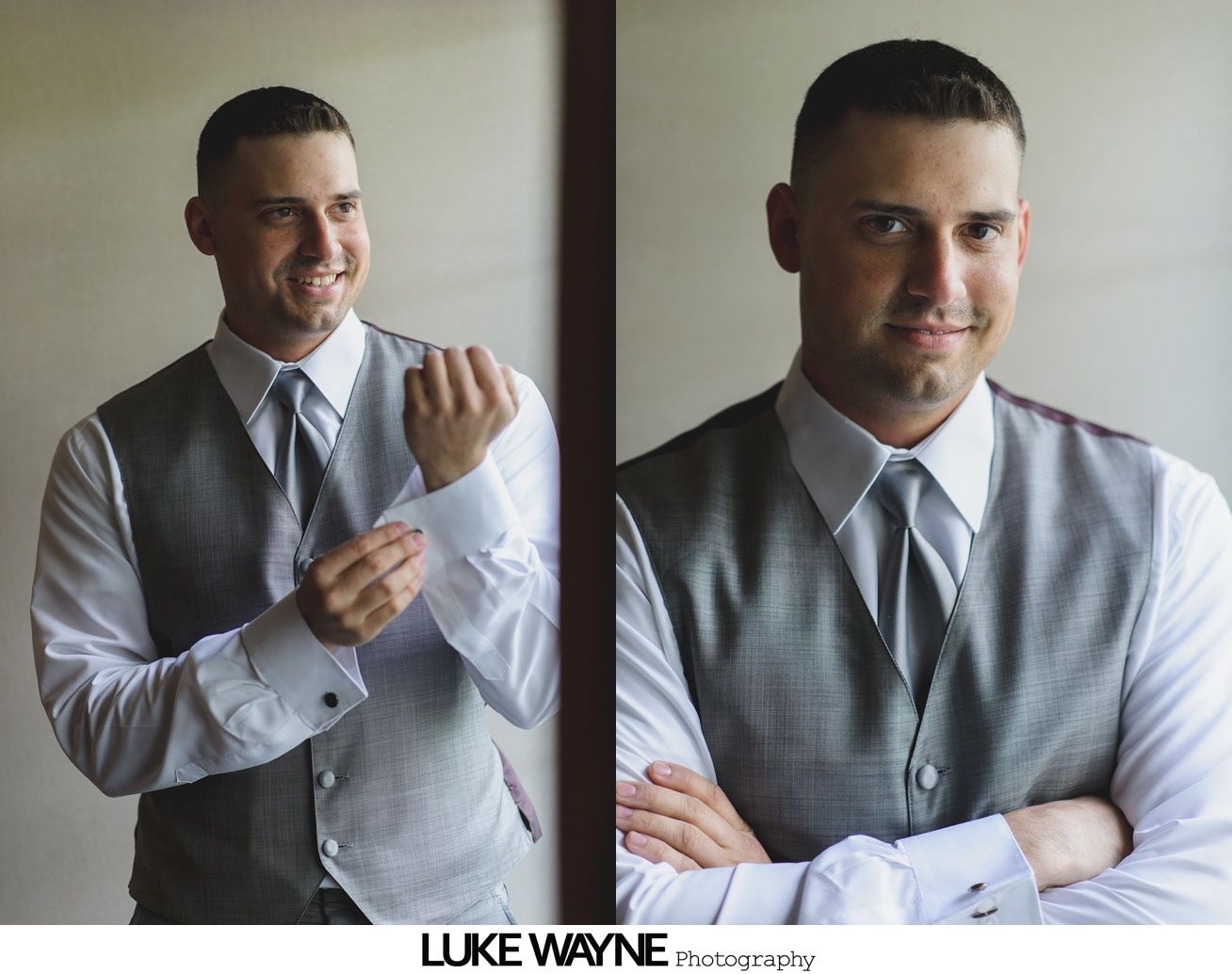 Man in vest and dress shirt adjusts cuff, posing near window.