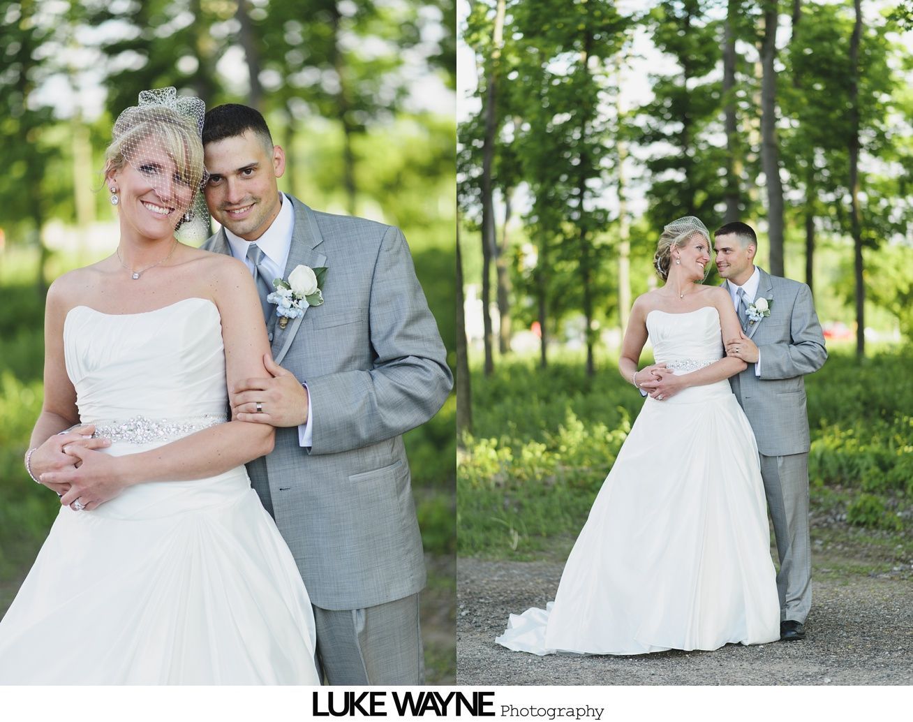 Wedding couple embraces outdoors, bride in white gown, groom in grey suit, smiling.