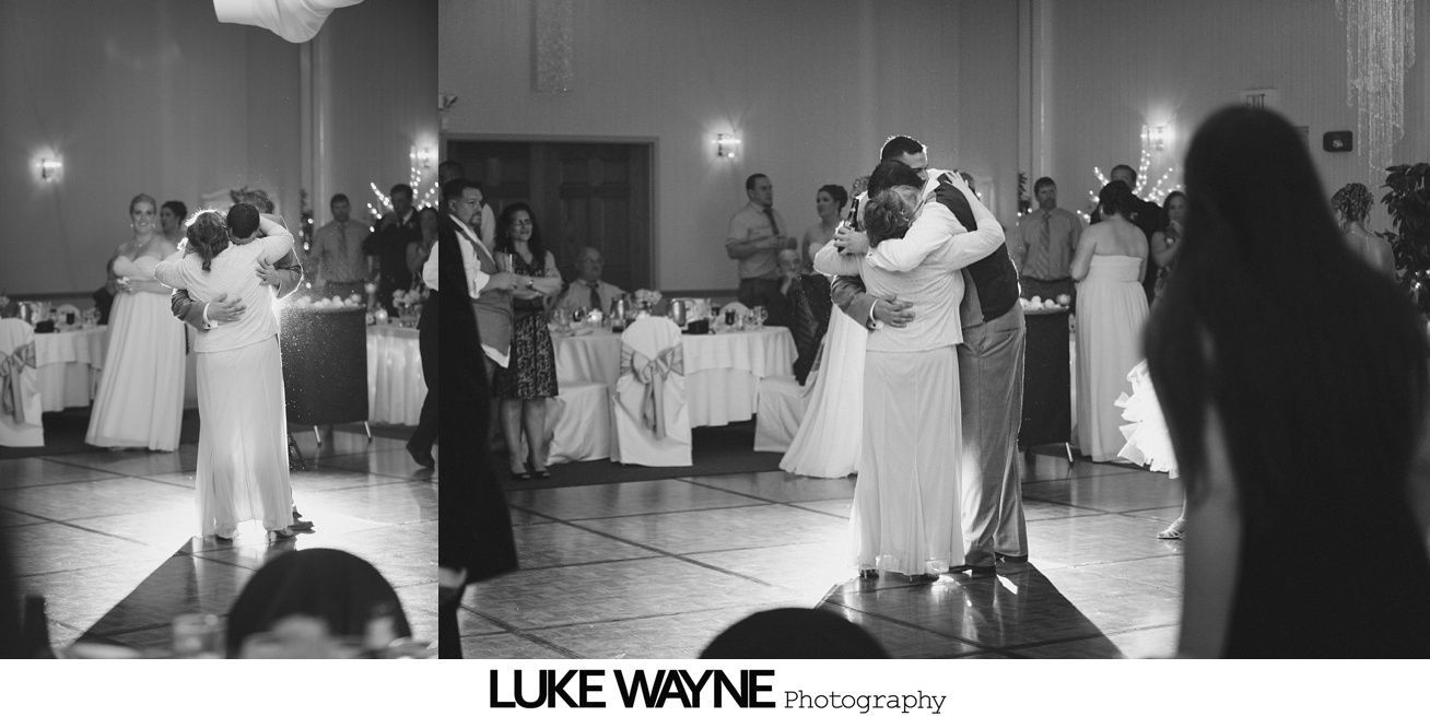 Wedding reception with couples dancing on a wooden floor in a ballroom.