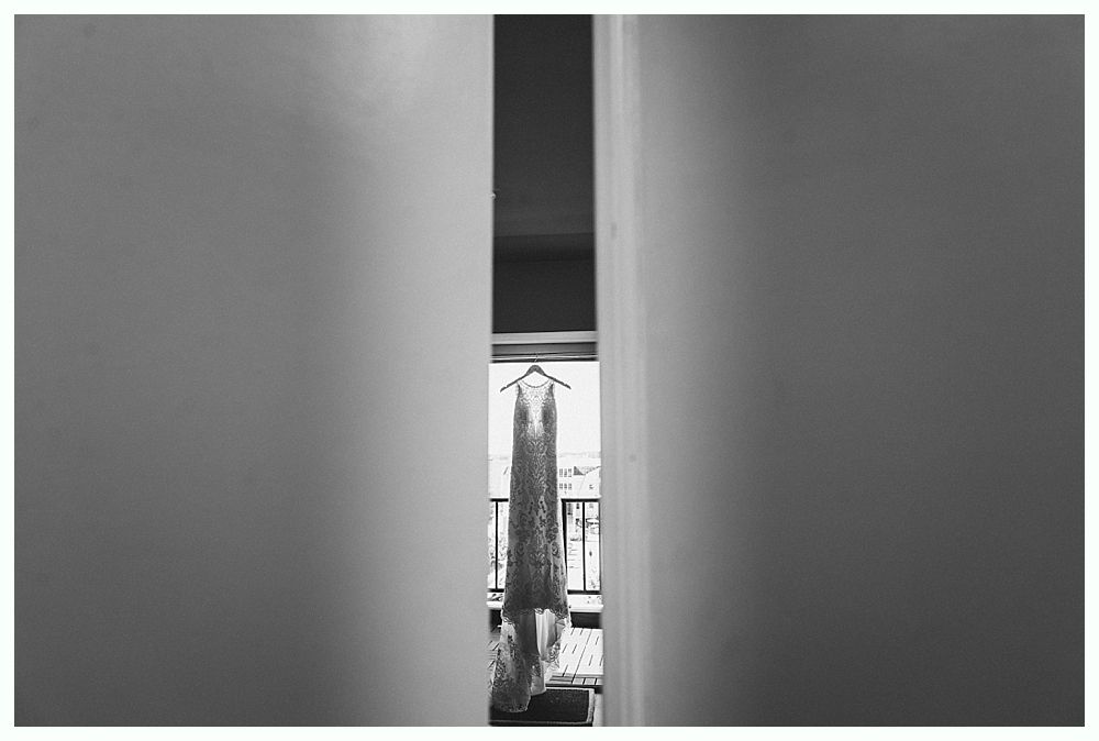 Wedding dress hanging between two walls.