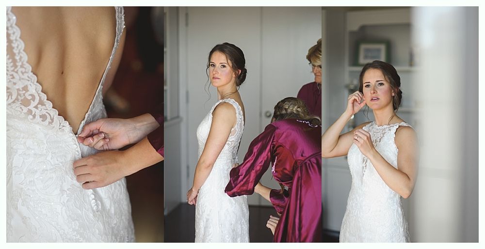Bride zipping up wedding dress, with help from others.