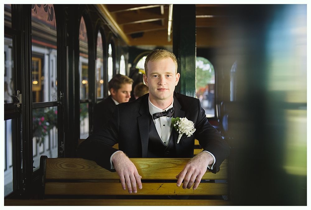 Triptych of wedding reception details: chandelier over table, drink station, and table setting with lights.