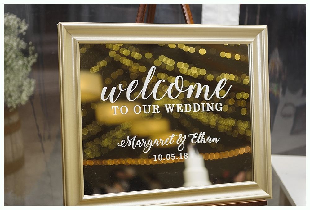 Gold-framed wedding sign with 