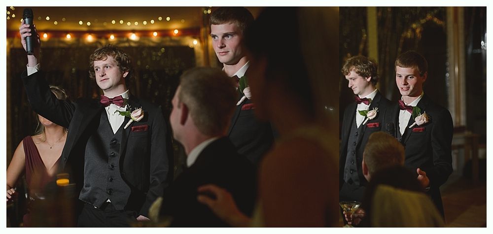 Groom giving a speech at a wedding, holding a microphone. Other guests are present in formal attire.