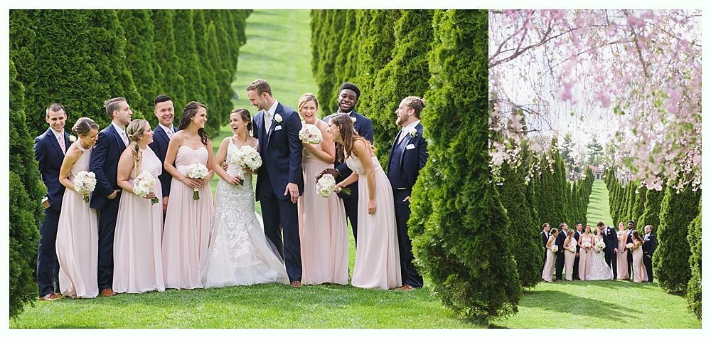 Wedding party posing in a formal garden. Bride and groom with bridesmaids and groomsmen.