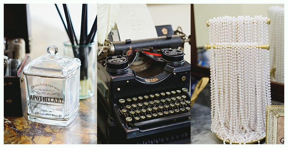 Glass jar, vintage typewriter, and pearl beaded purse on a table.