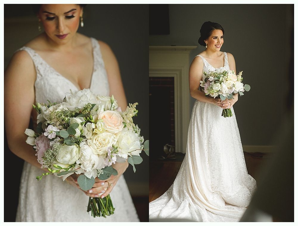 Bride in white lace dress holding a floral bouquet.
