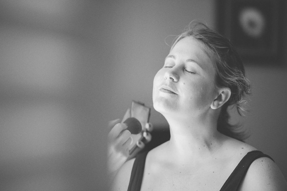 Wedding party toasting with beer bottles in an outdoor setting; sunflowers and smiles.