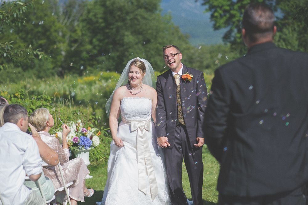 Wedding tables decorated with sunflowers, yellow boxes, and white linens.