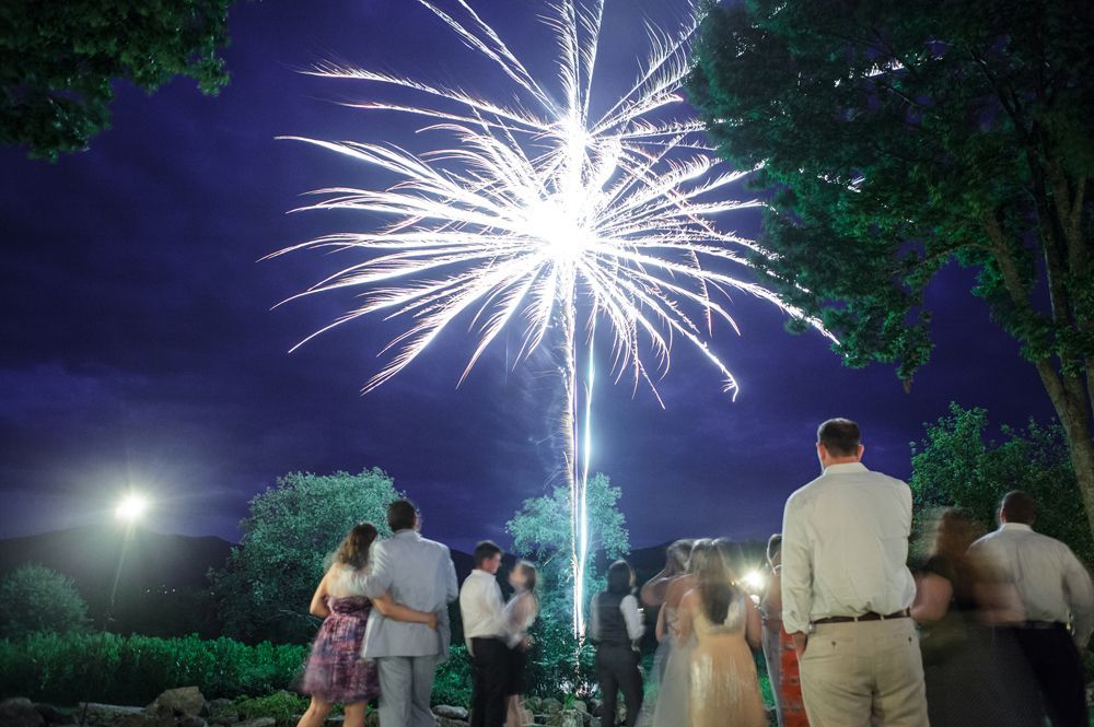 Person taking photo in mirror, indoors; black and white.
