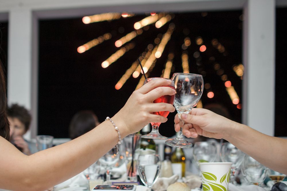 Person taking photo in mirror, indoors; black and white.