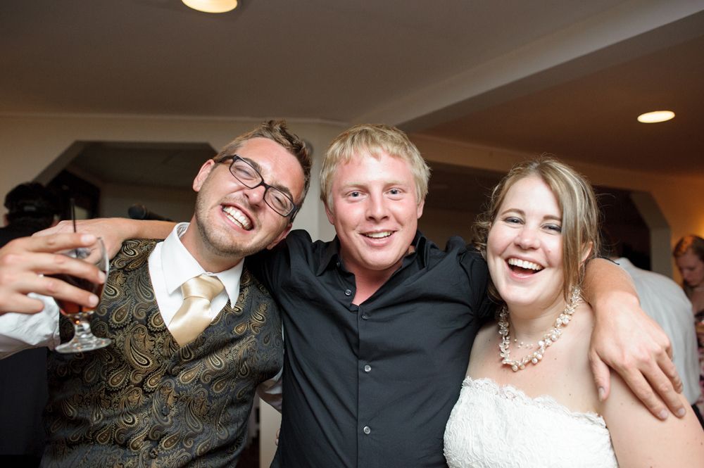 Person taking photo in mirror, indoors; black and white.