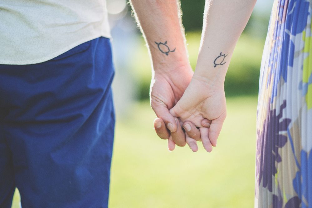 Man adjusting his suit: buttons, tie, and cufflinks. Black and white.