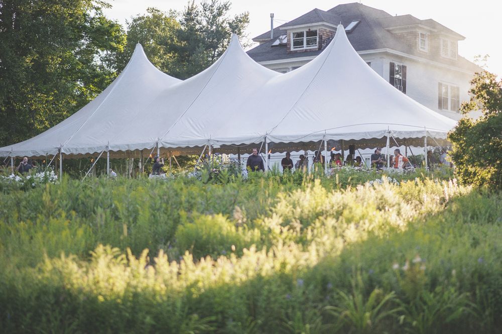 Man in suit stands in hotel hallway, smiling.