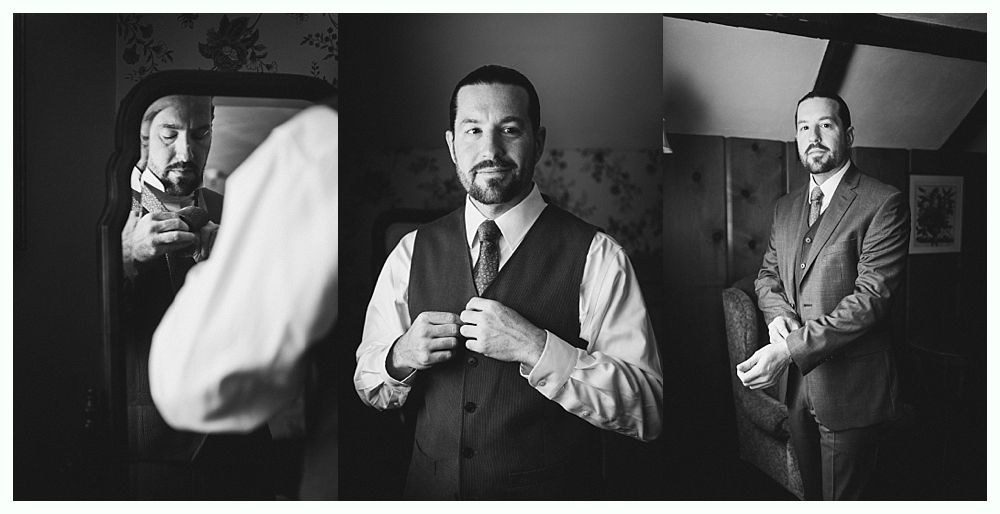 Man in waistcoat and suit jacket adjusting clothing, getting ready in a room with a mirror and wood paneling.