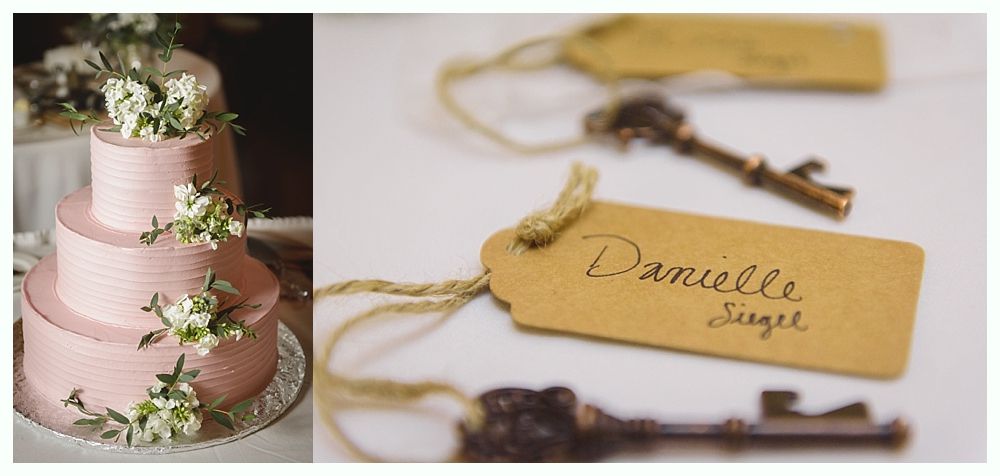 Pink tiered cake with floral accents and name tags with keys for place settings.