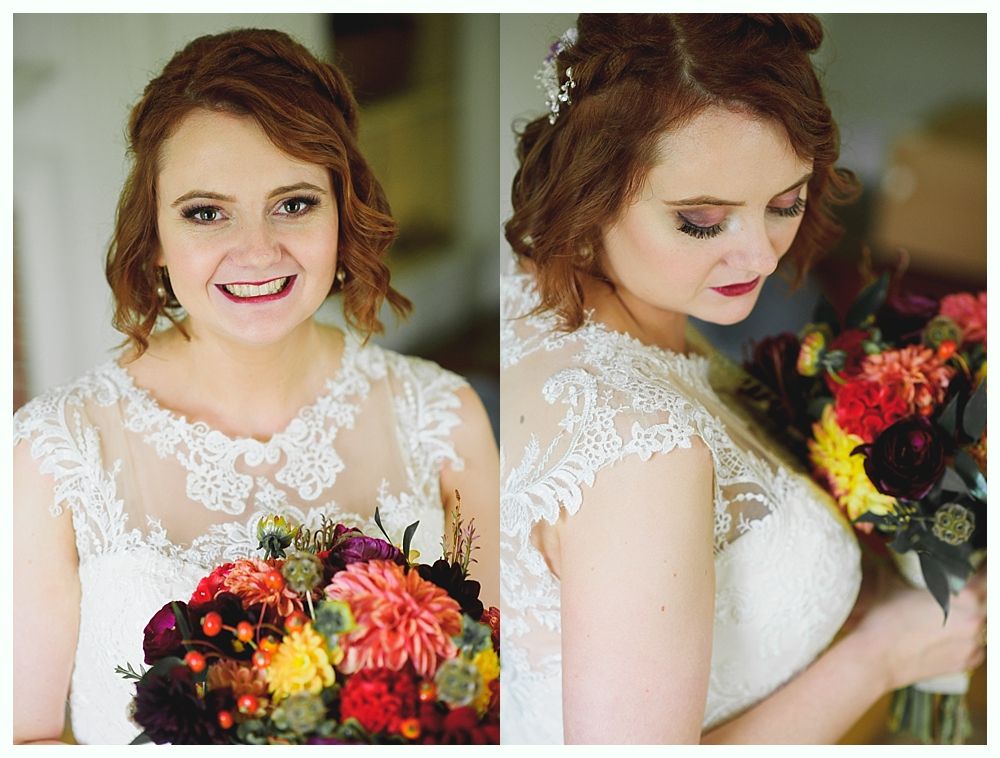 Woman in a white lace wedding dress smiles, holding colorful bouquet.