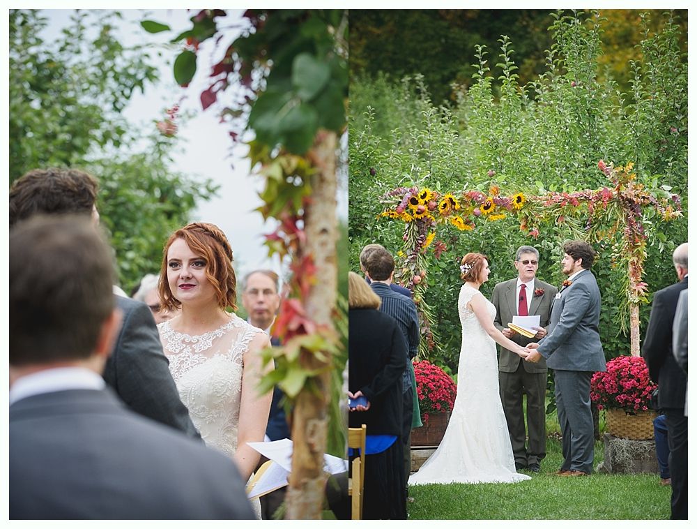 Wedding ceremony: bride and groom holding hands under an arch, guests watch. Autumn setting with floral decorations.