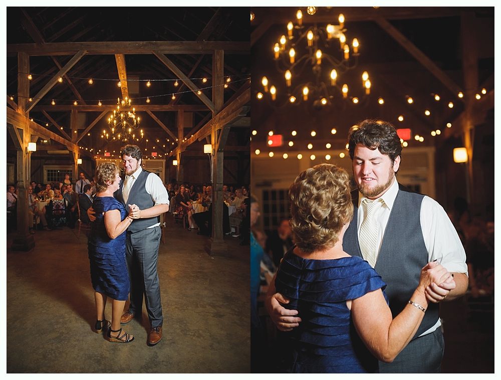 Man dances with a woman, at a wedding reception. Lit with warm lights.