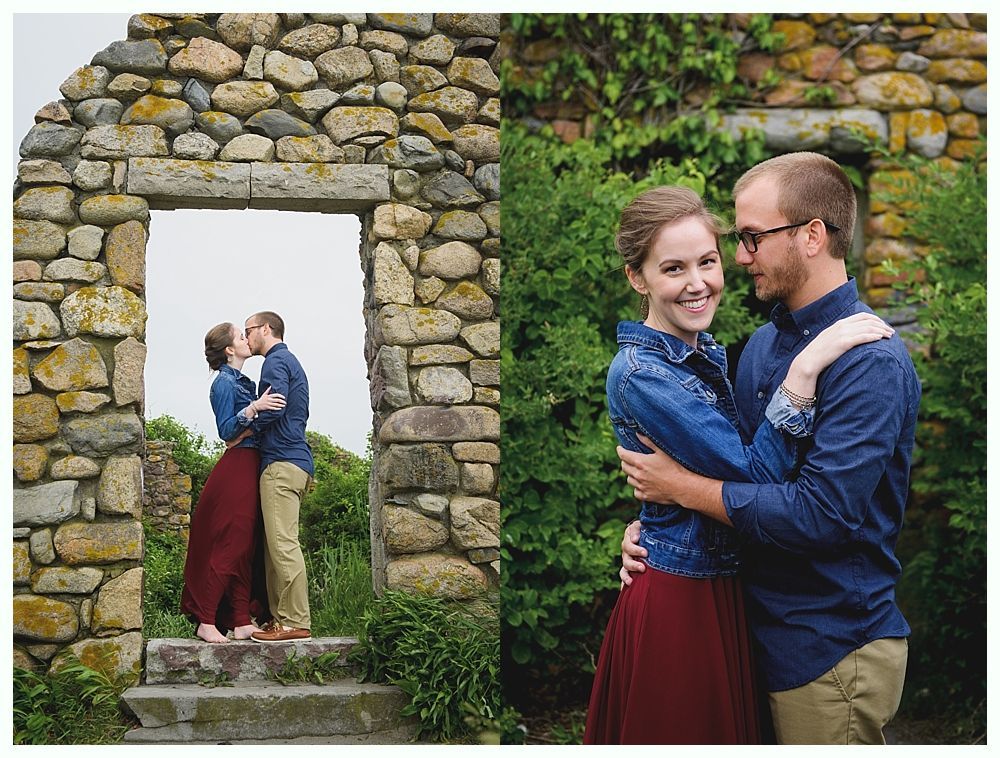 Couple kissing, framed by stone structure; posed embracing outdoors.