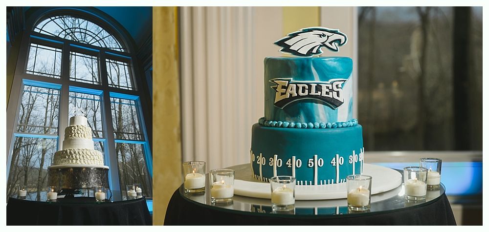 Two-tiered teal cake with Philadelphia Eagles logo, on a table. Next to a white, tiered cake.