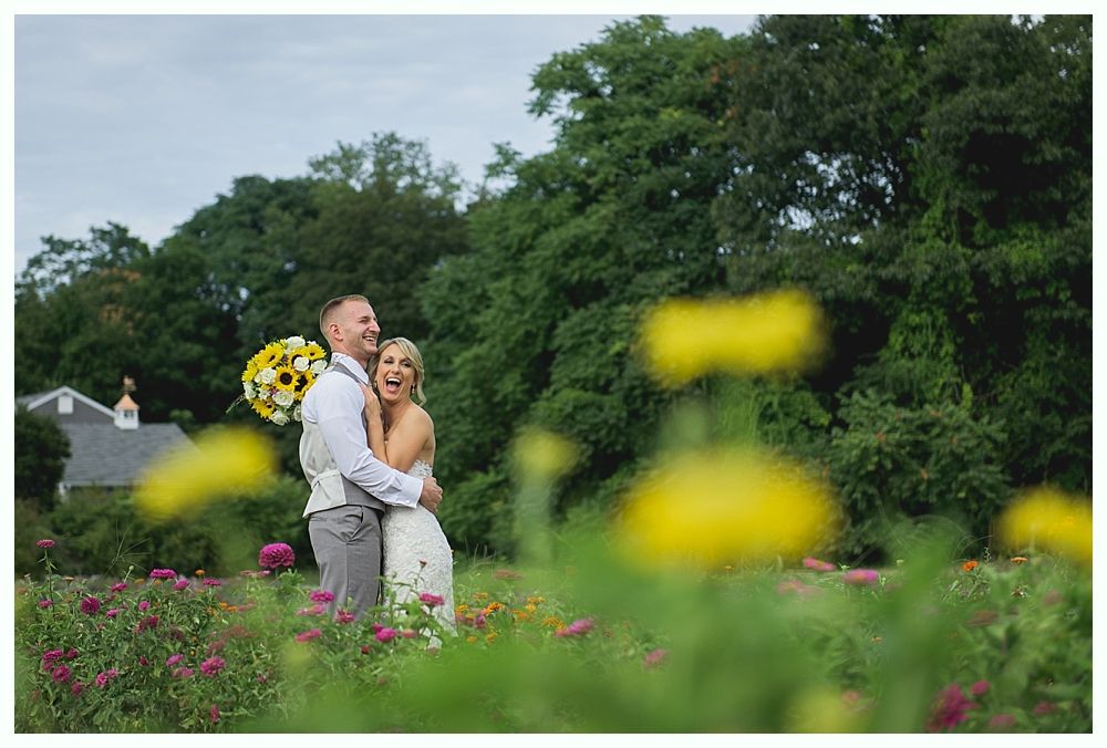 Groomsmen and a young boy stand on a road with yellow lines, wearing suits and looking at the camera.