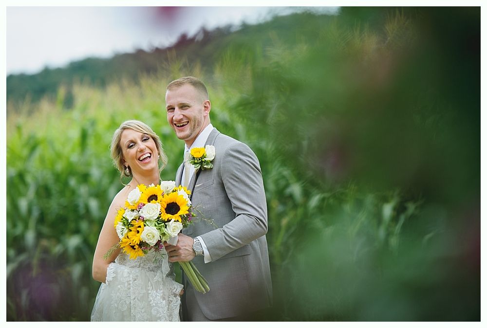 Bride and her father walking towards the camera through a doorway during a wedding. They are smiling.