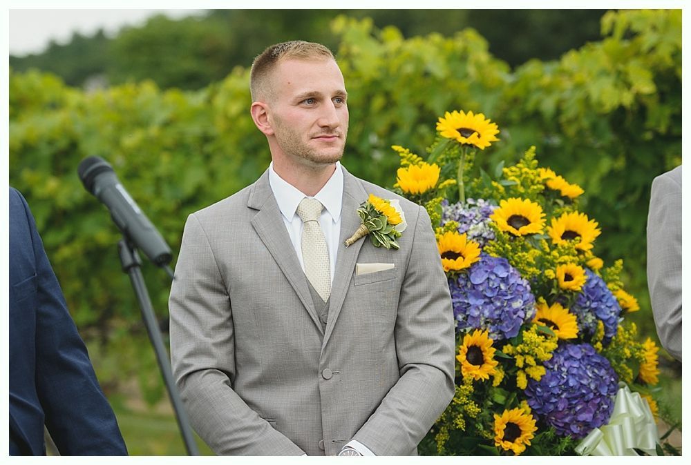 Bride and groom at altar during wedding ceremony; guests seated in pews.