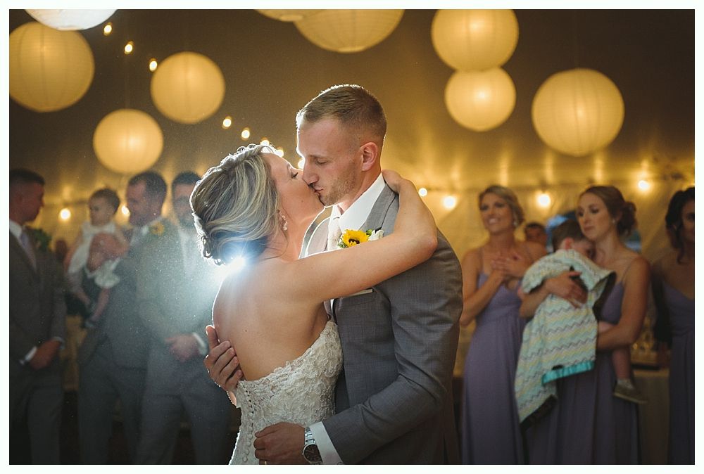 People toasting with champagne flutes at a wedding reception; happy faces and festive atmosphere.