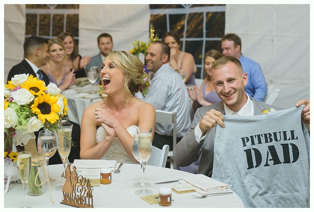 Bride and father share an emotional dance at wedding reception, both with heads touching and eyes closed.