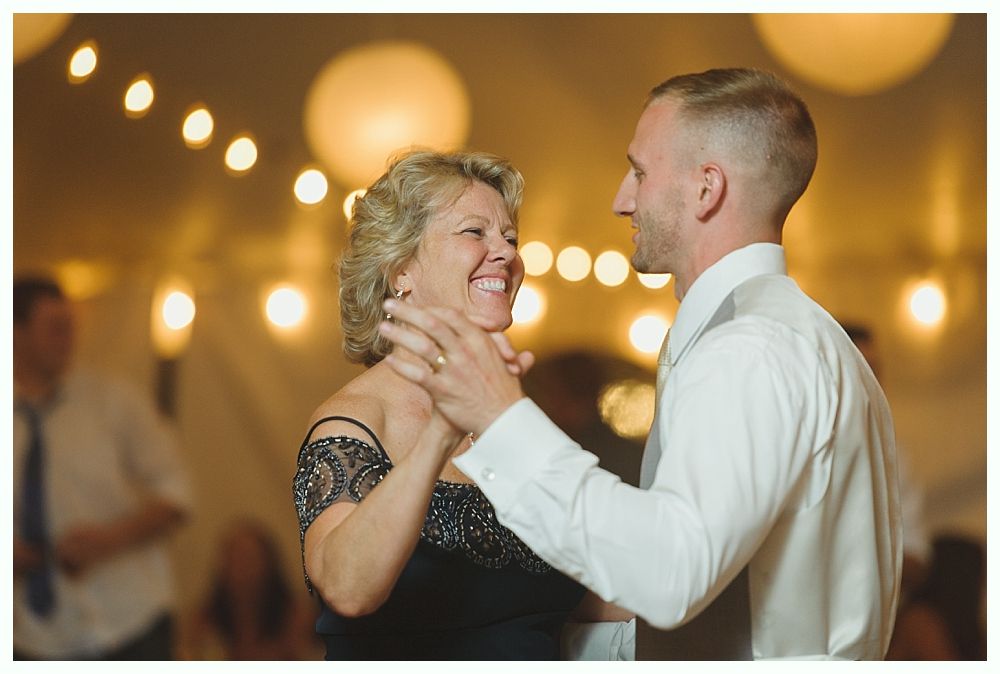Wedding party: couple and attendants posing with champagne bottles. Night setting, gold and blue attire.