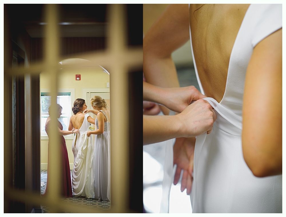 Bride and bridesmaids in navy dresses hold bouquets, posing outdoors.