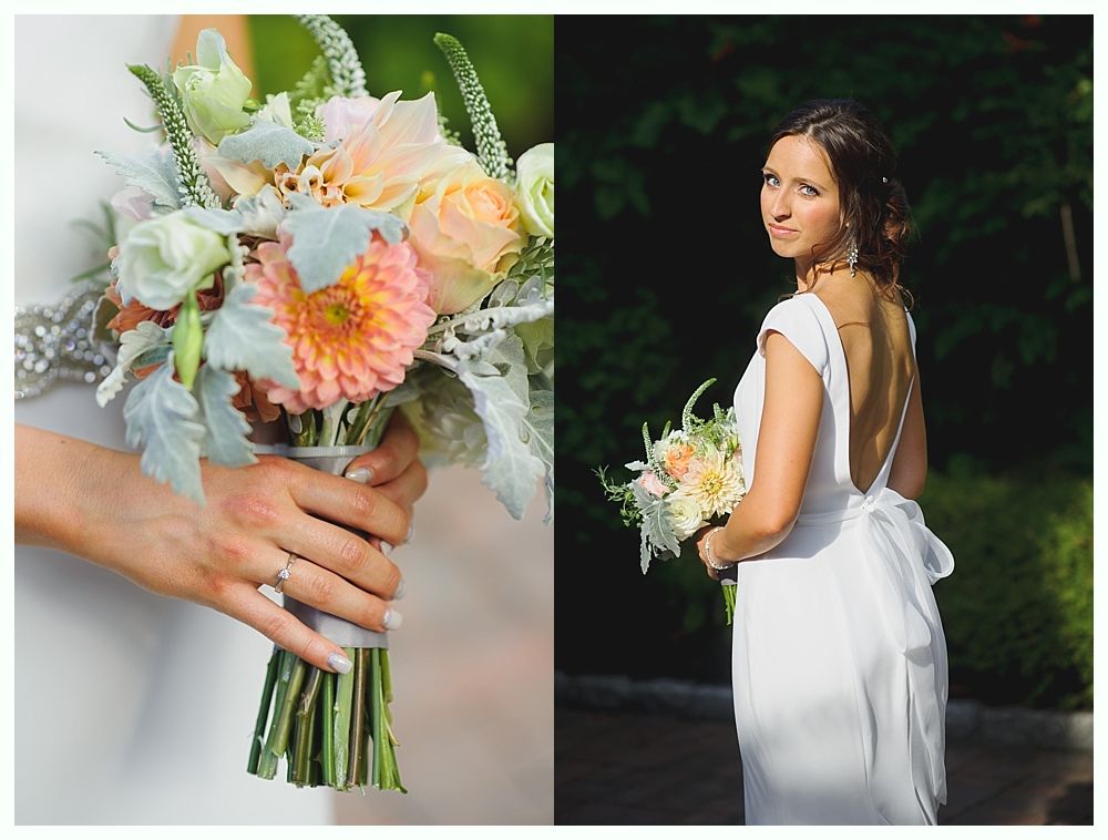 Bride and groom embrace on rocks by the ocean at sunset. The groom wears a blue suit, the bride a white dress.
