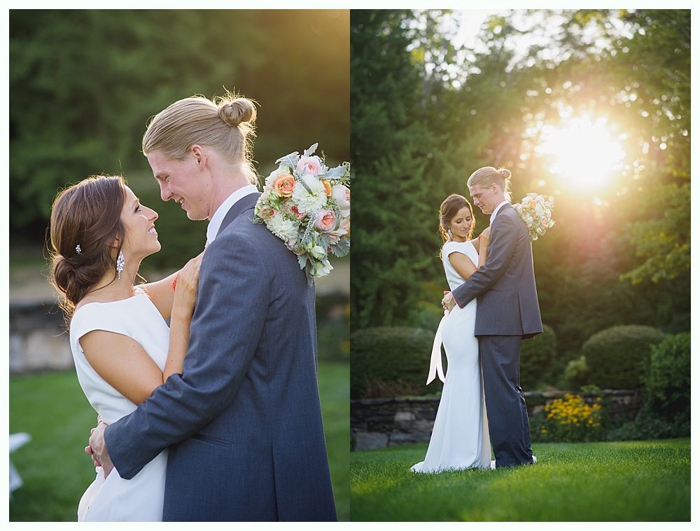 Bride with arms up, making a funny face, groom looking at his hand, cake cutting in background.