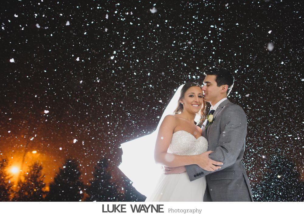 Wedding reception details: cake, flowers, wine, purple and white decor.