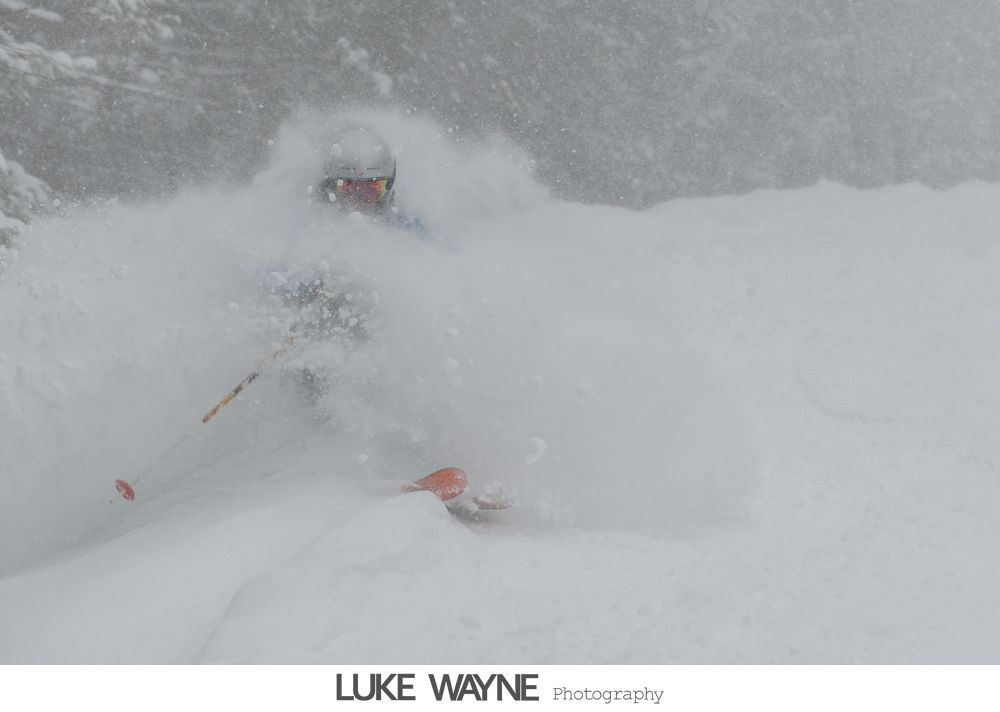 Silhouette of someone applying makeup near a window, natural light.