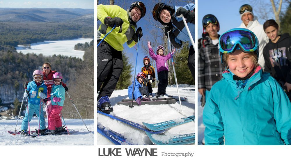 Six men in suits pose on steps by a street. One man has arms open, others smile or look at the camera. A bus and car are in the background.