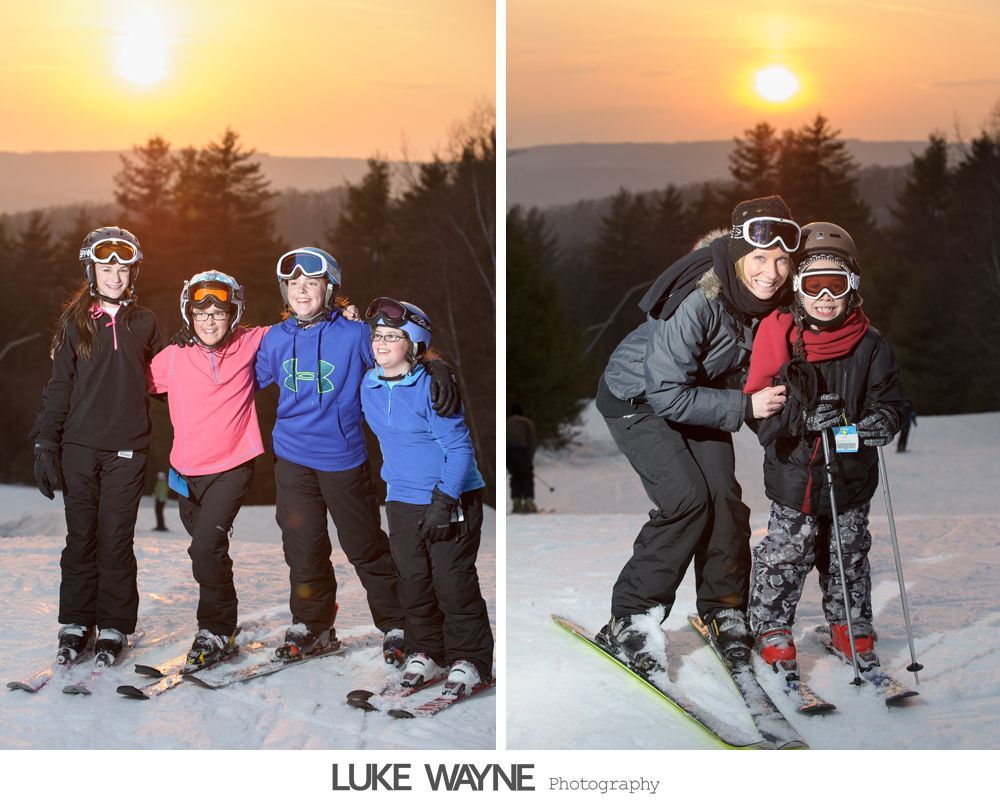 Bride in white dress laughs with bridesmaids in purple gowns.