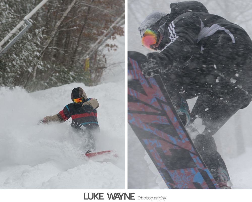 Couple in wedding attire posing in a bar. The woman's dress is white, the man's suit grey, both smiling.