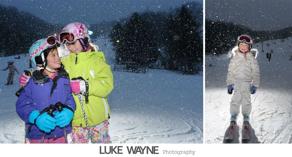 Bride and groom exit a building, holding arms, smiling. Bright sun streams through windows.