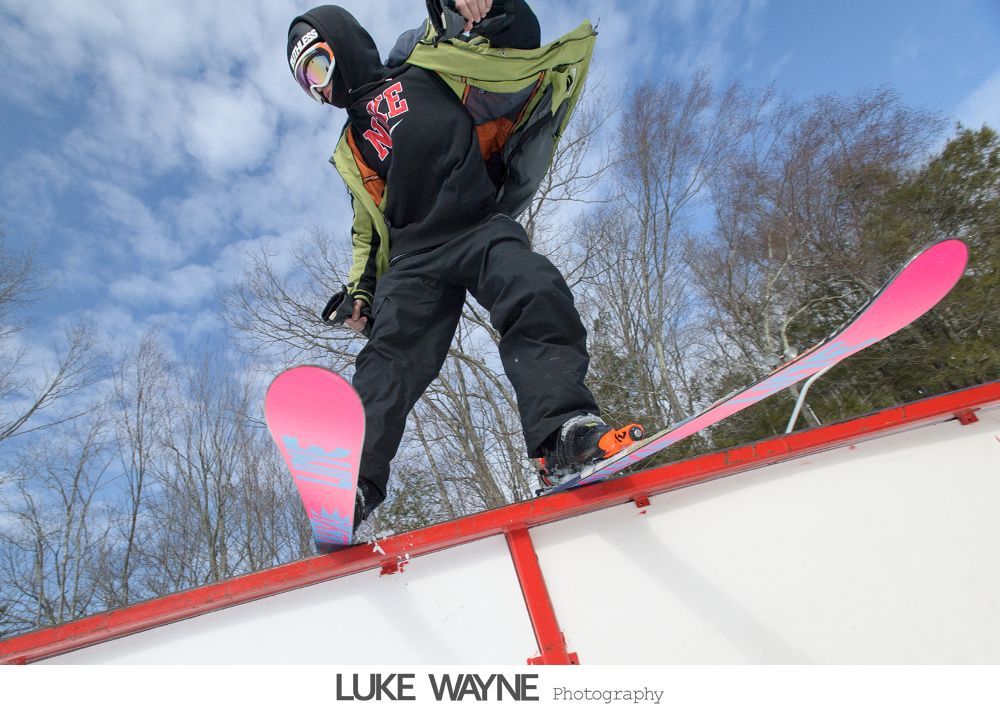 Wedding reception details: cake, flowers, wine, purple and white decor.
