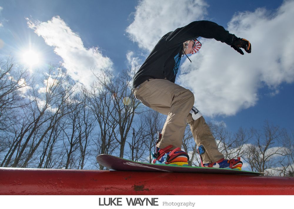Bride in a strapless gown surrounded by people. Black and white photo.